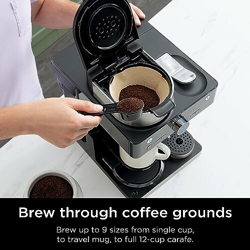 Person using coffee maker with coffee grounds