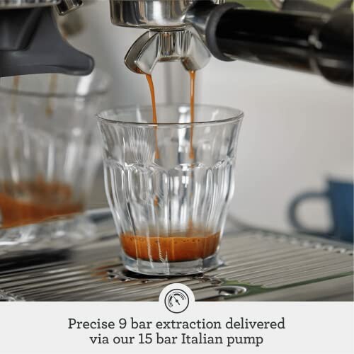 Espresso being extracted into a glass from a coffee machine